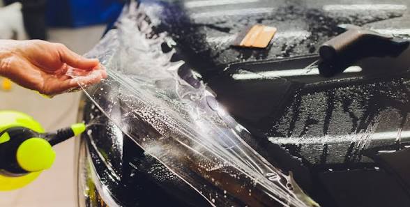 PPF being installed on a vehicle hood
