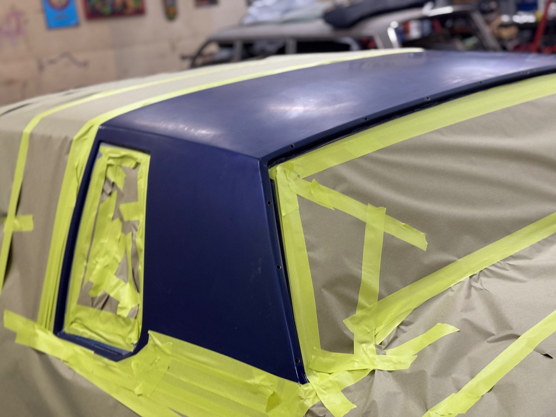 Fresh deep blue roof paint — masked and laid down